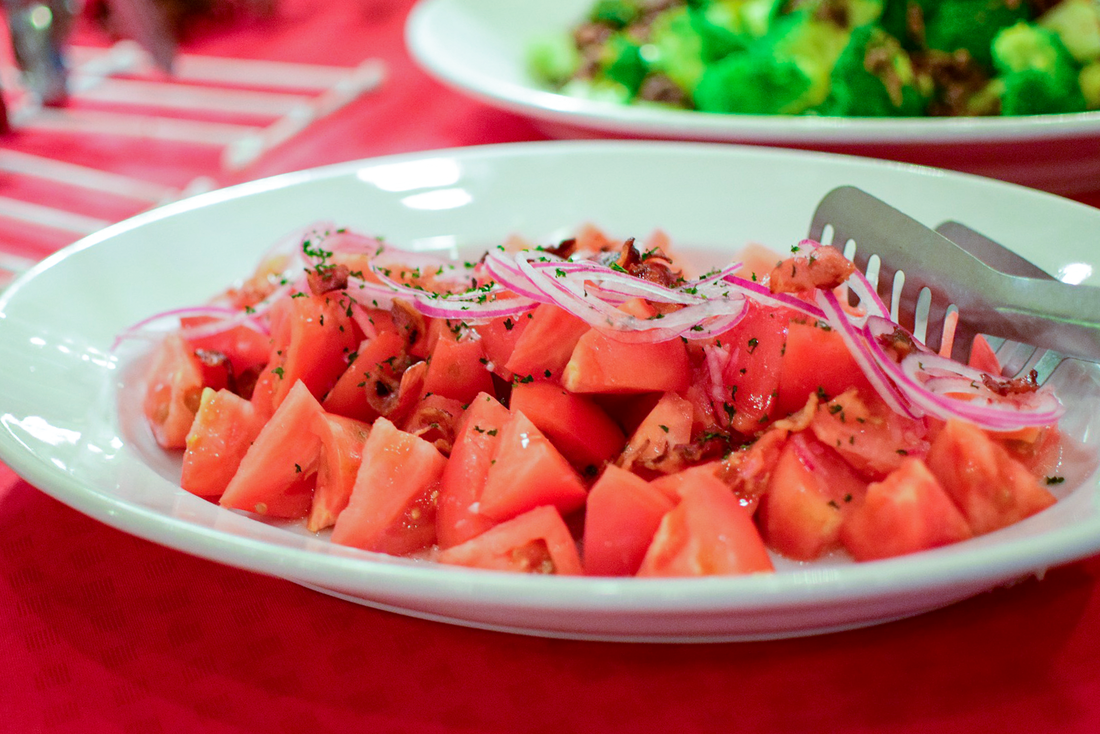 Diced tomatoes with red onions on a white plate