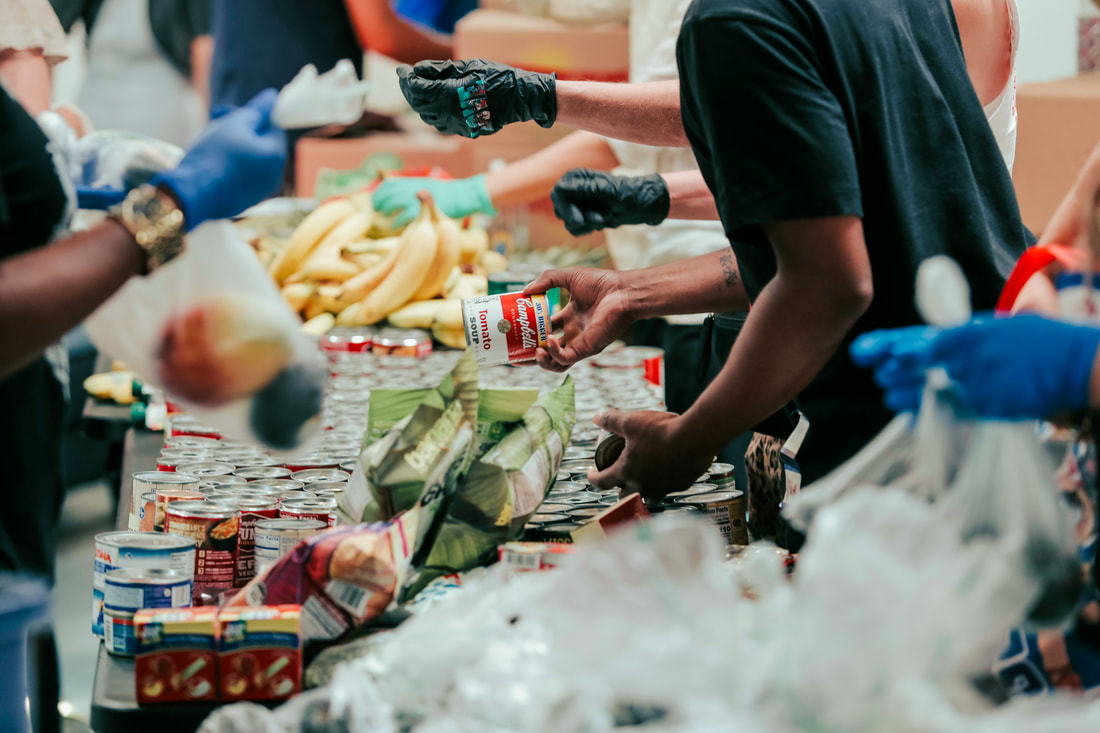 Volunteers help sort food
