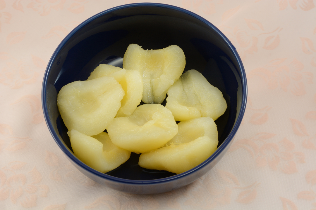 Pear halves in a navy bowl